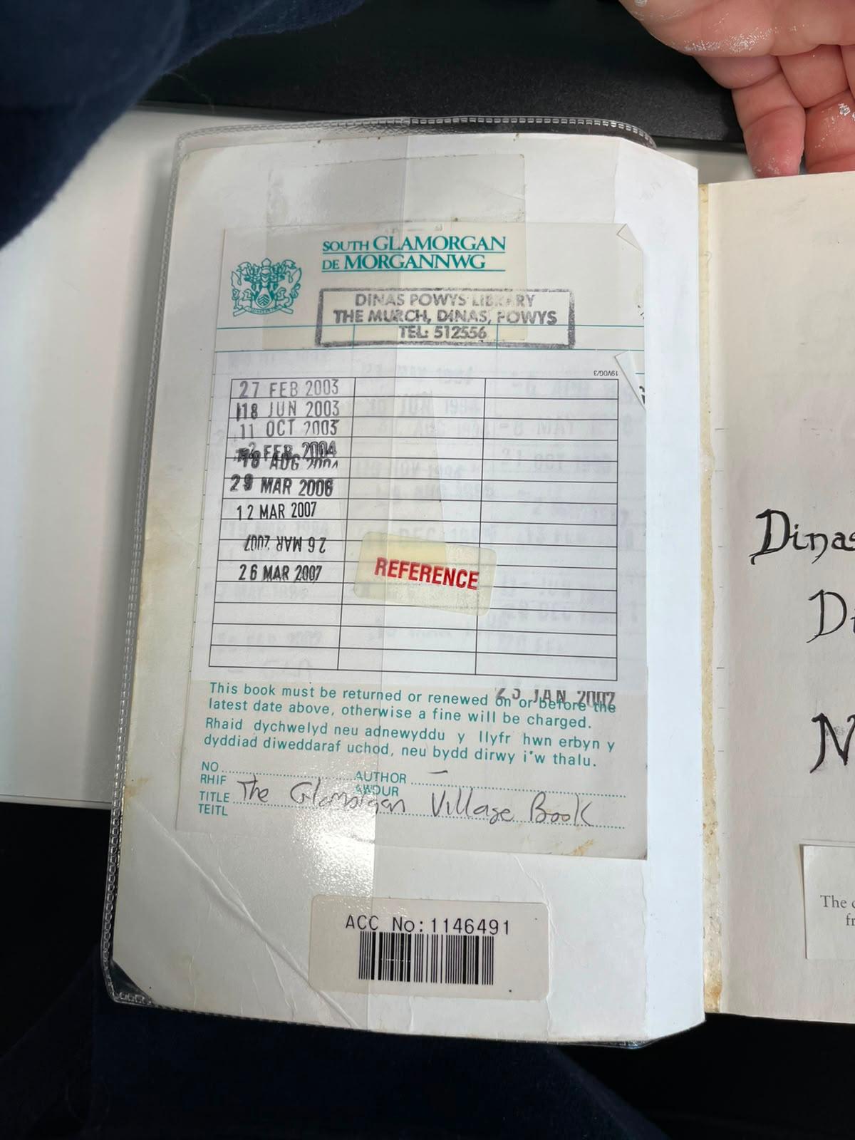 Photograph of the book’s library/reference page, showing Dinas Powys library stamps, reference marking and accession number.